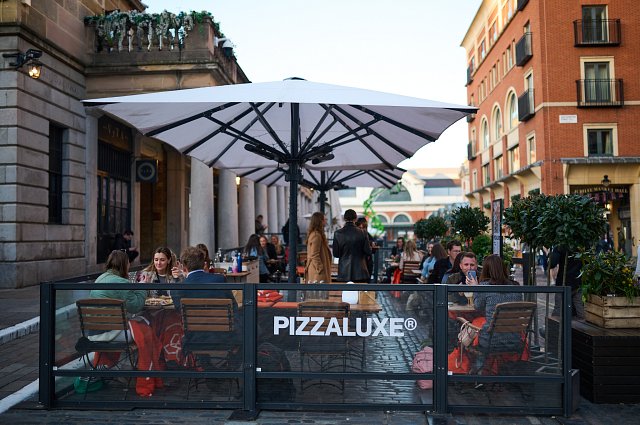 The PizzaLuxe Covent Garden terrace space, with people dining alfresco