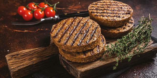 Grilled plant-based patties and vine tomatoes